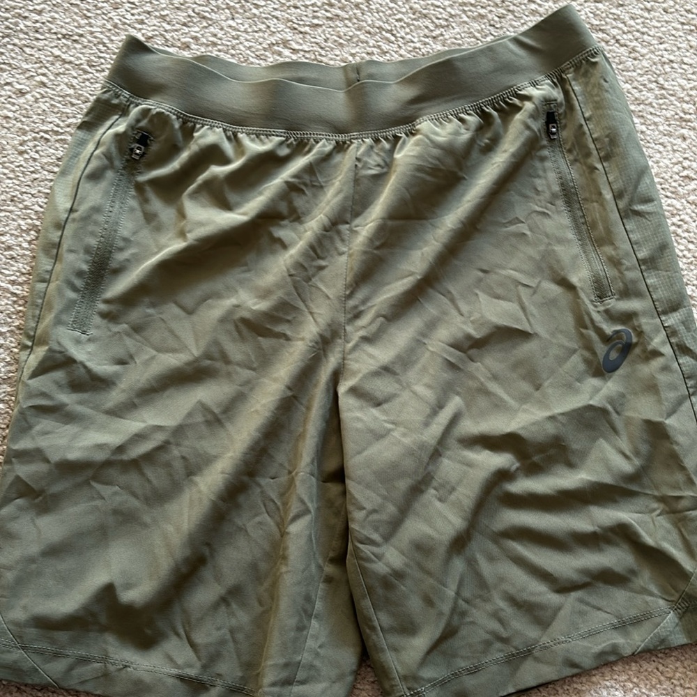 ASICS men’s running shorts with zipper pockets. Good condition. Light green